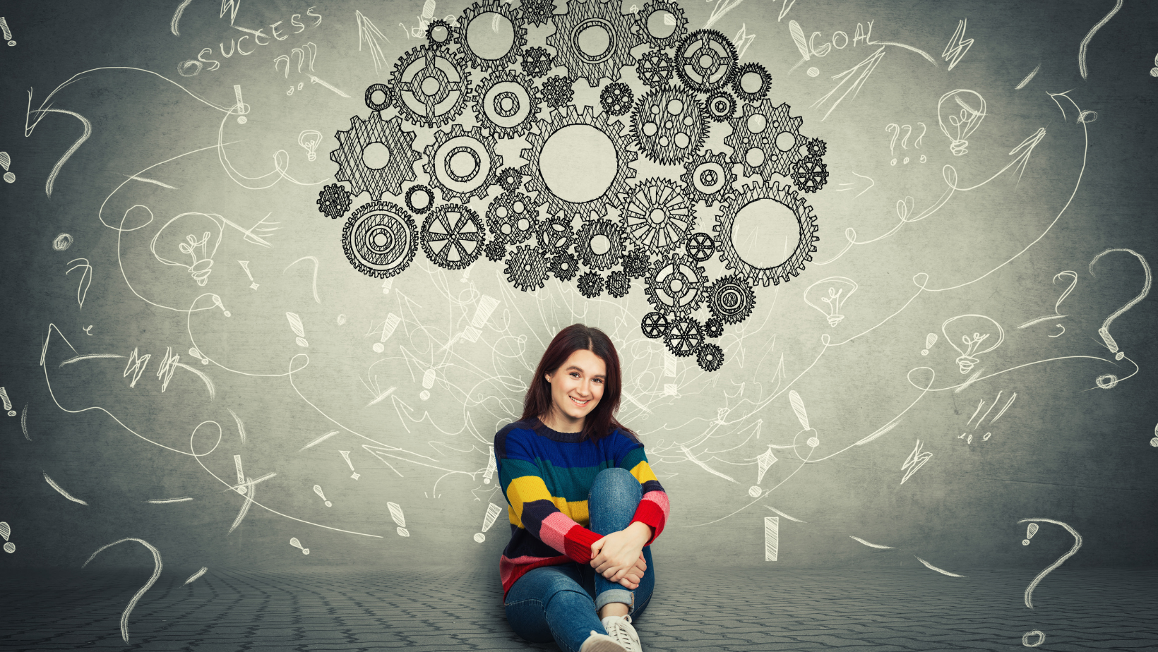 A young woman in a colorful sweater sits on the floor, smiling, with illustrated gears and doodles forming a thought cloud above her head, symbolizing creativity, brainstorming, and the importance of Brain Injury Education.